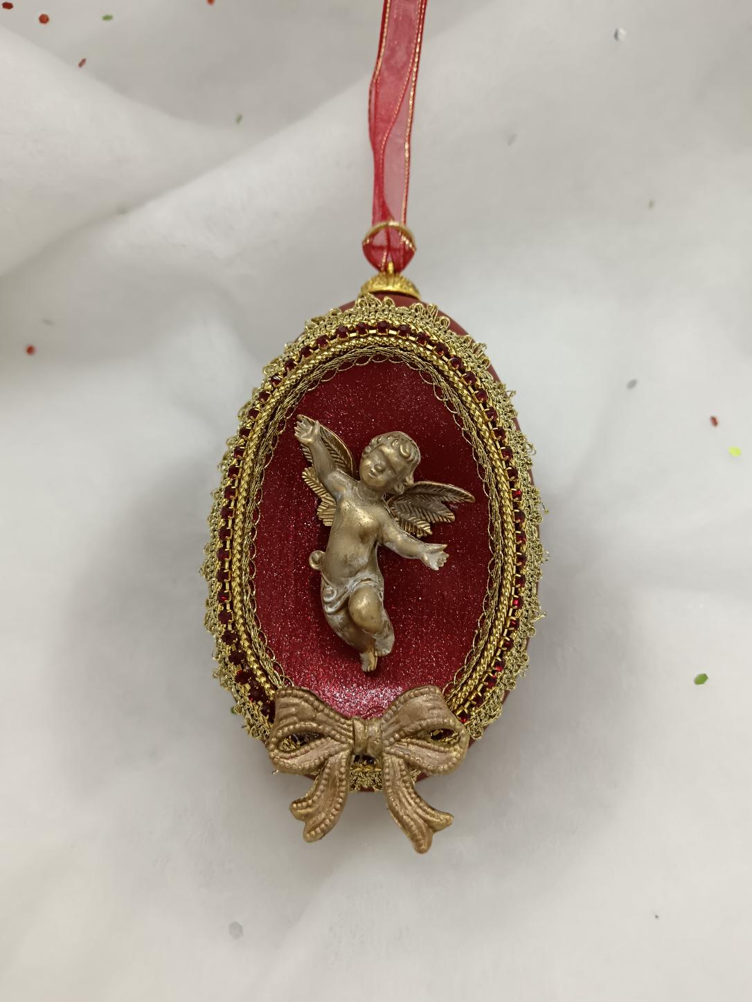 Gold angel on a burgandy Goose egg 